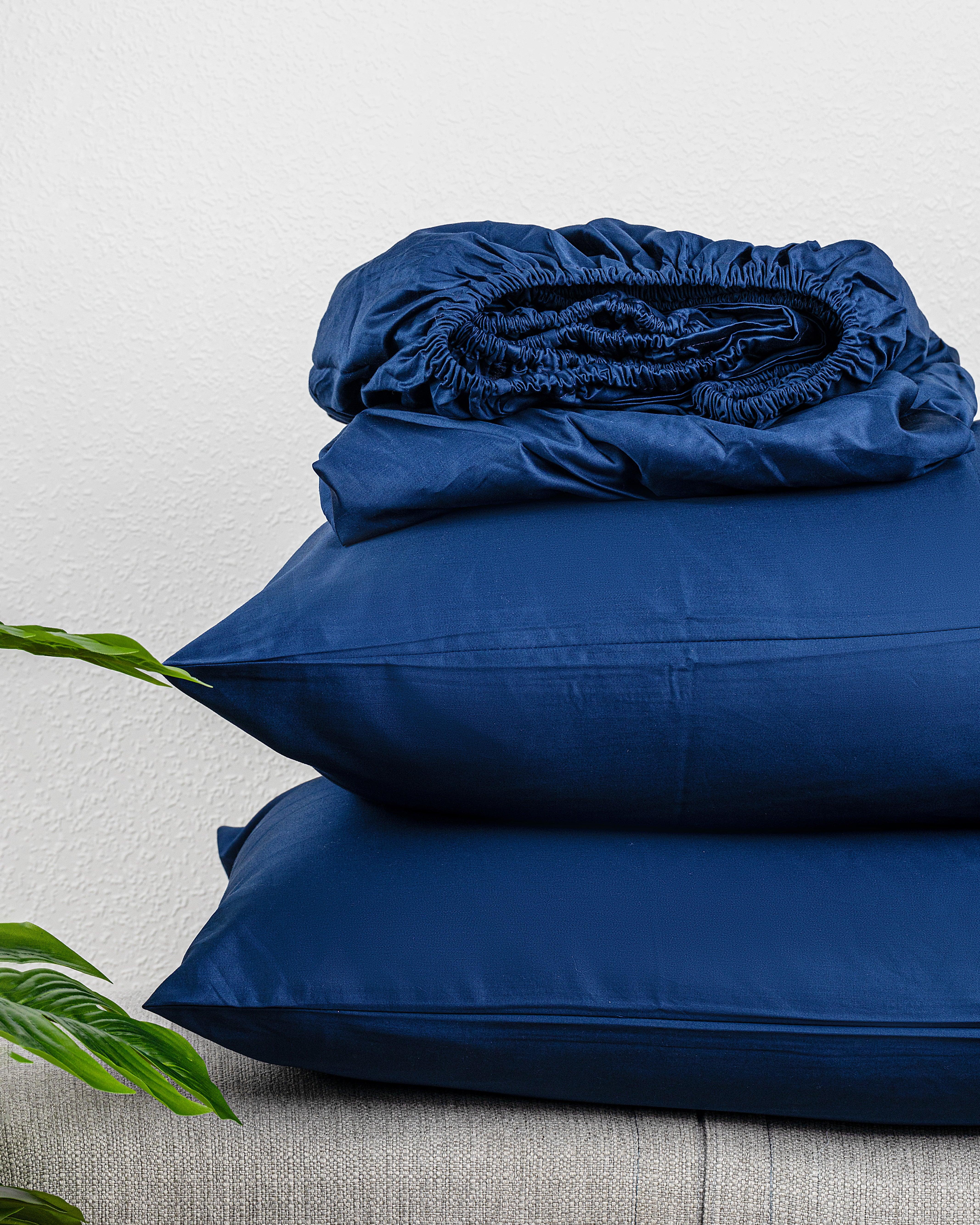 Regal Collection Fitted Sheet Set in blue cotton stacked neatly.