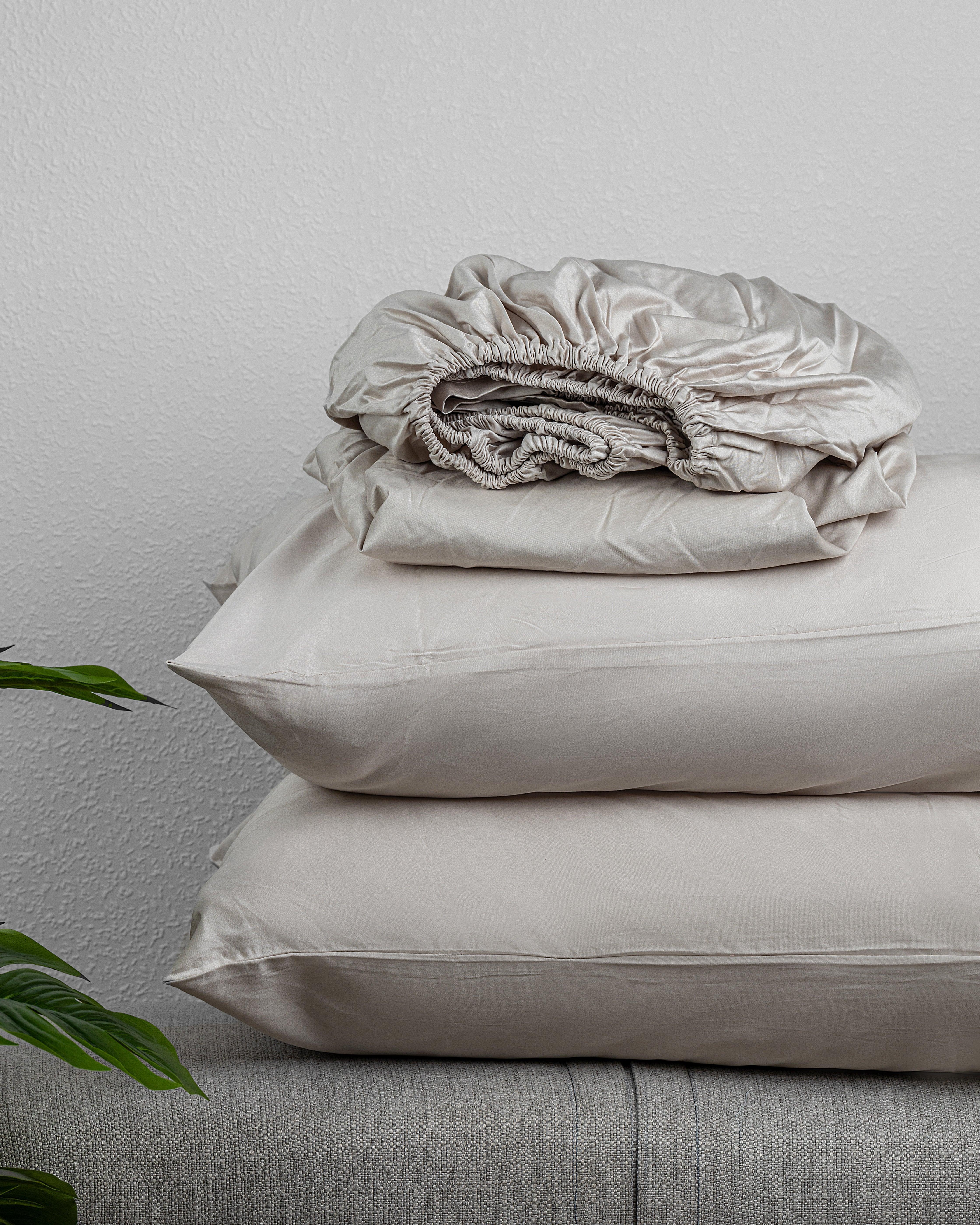 Regal Collection Fitted Sheet Set in high-quality cotton displayed on a sofa.