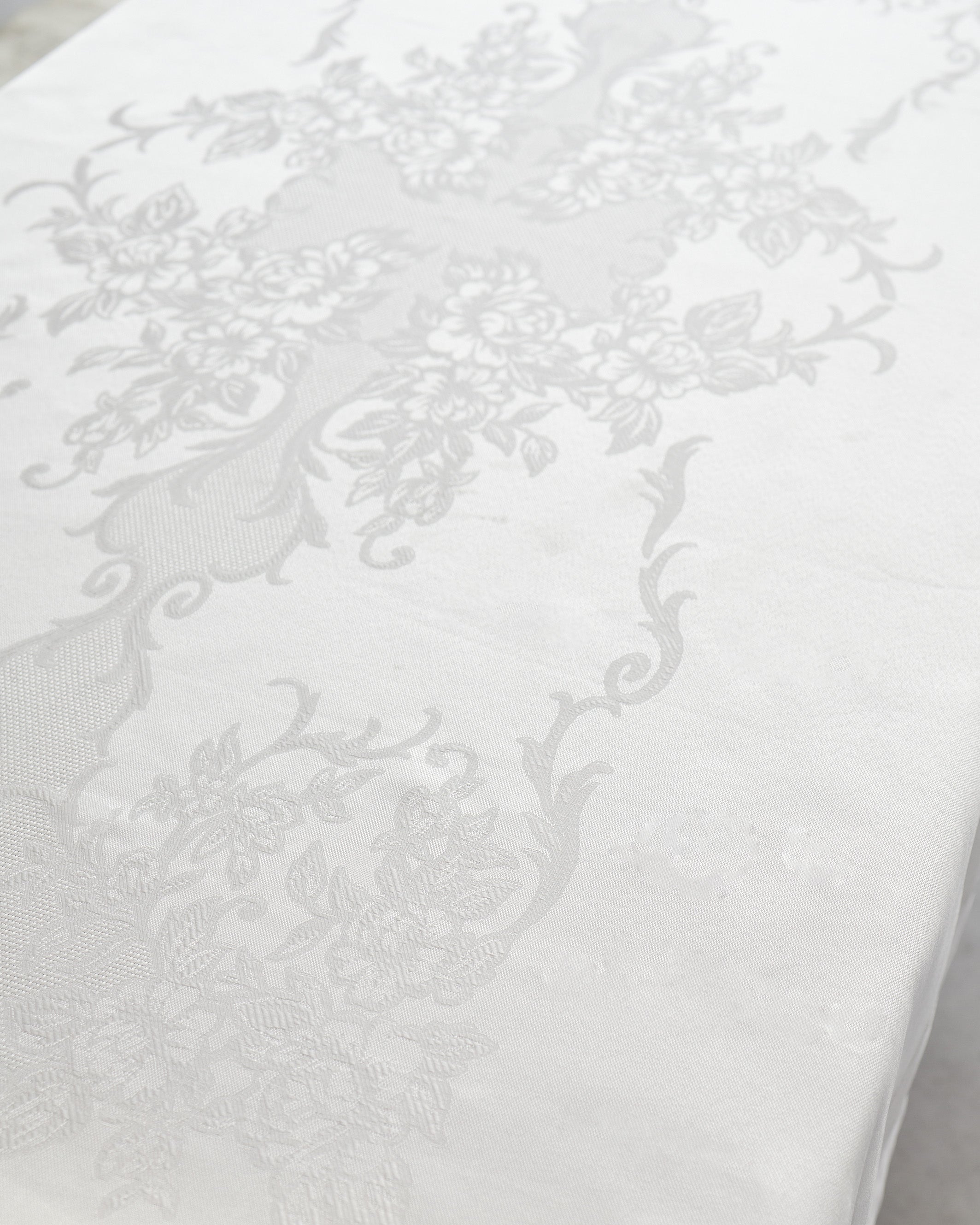 Lorena Table Cover with elegant floral pattern in smooth, easy-care fabric protecting table surface