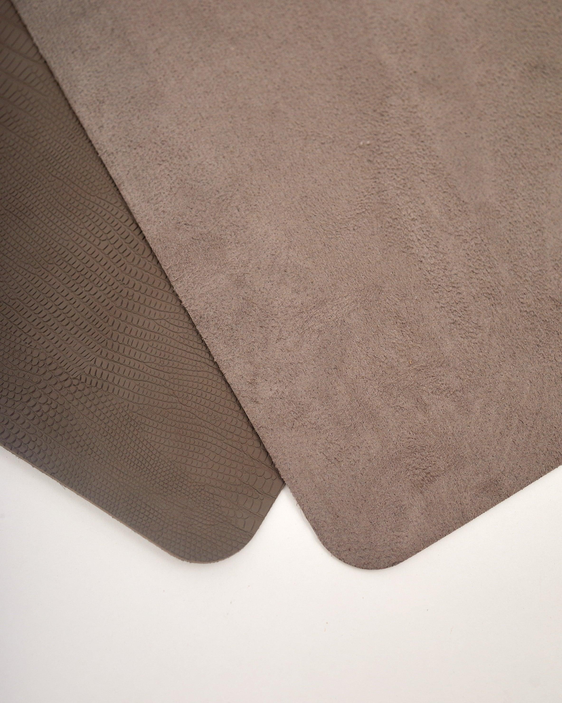 Set of two brown leather table mats with different textured surfaces for dining protection and style