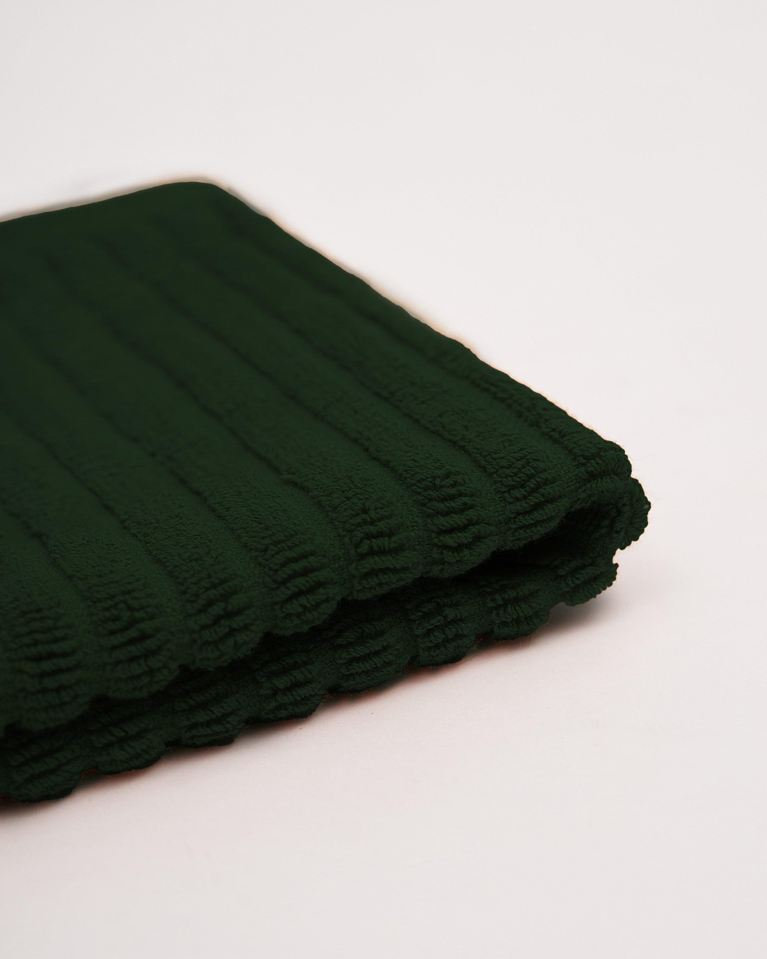 Dark green towel from the Linea Towel Collection.