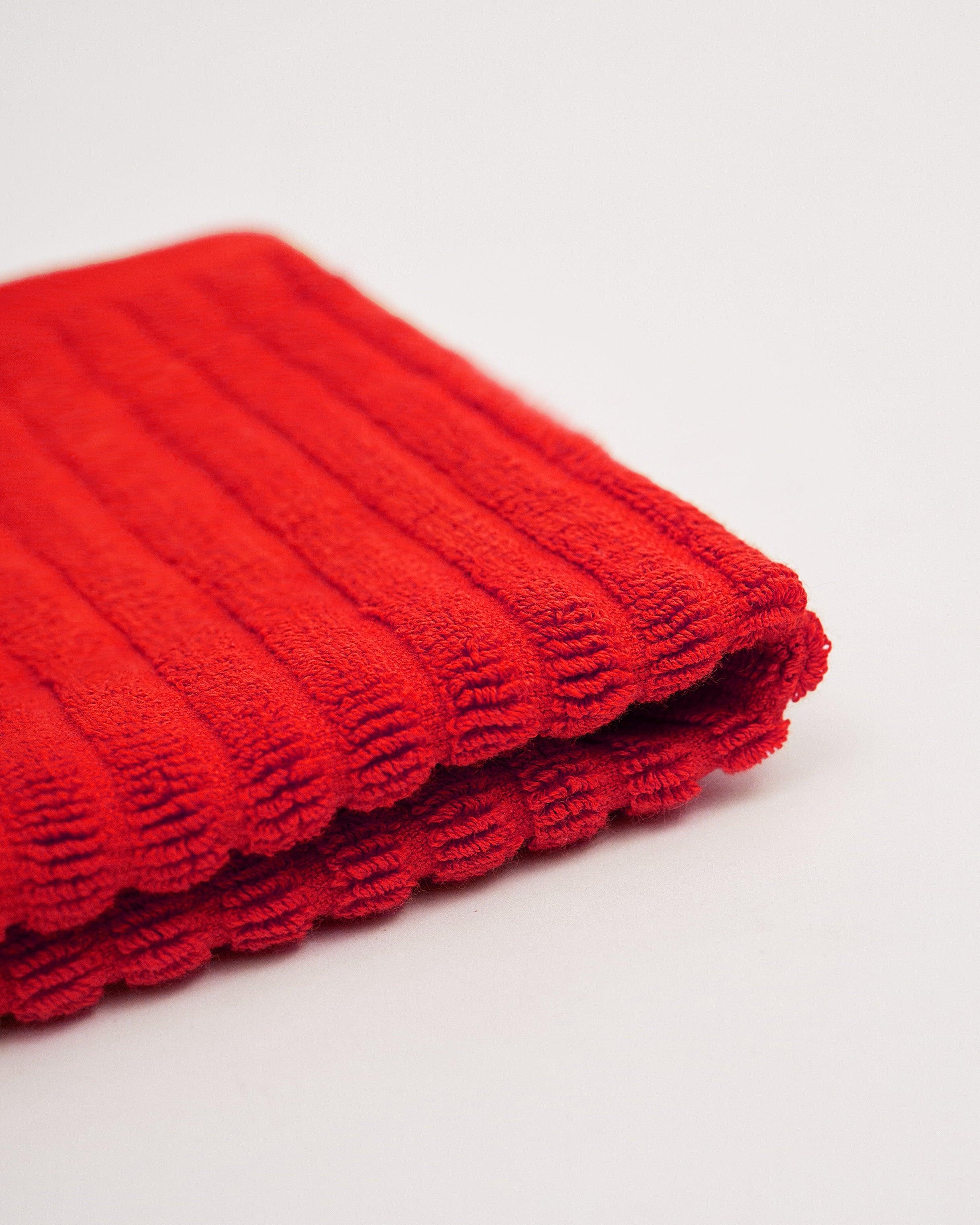 Red towel from the Linea Towel Collection.