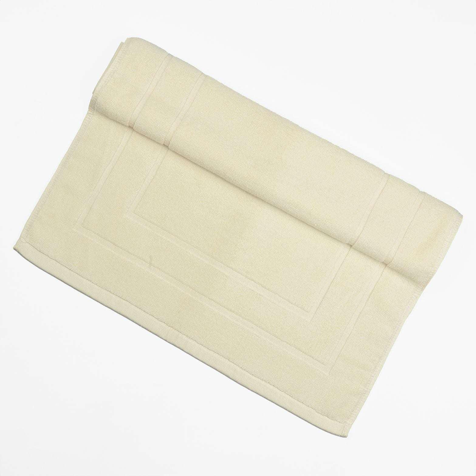 Deluxe Bath Mat in cream color, plush and moisture-absorbing.