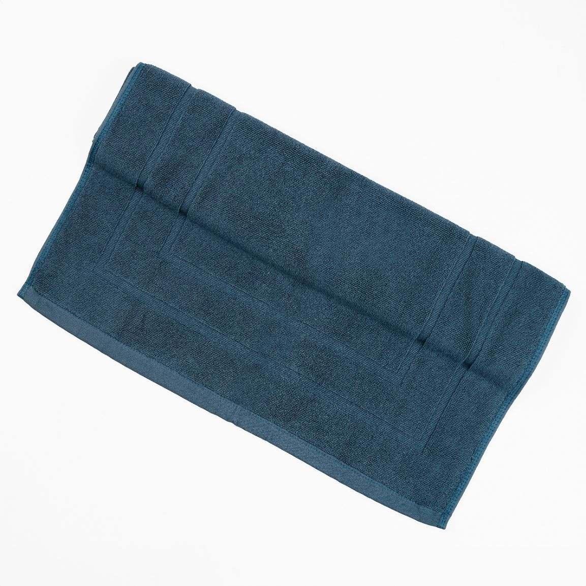 Blue deluxe bath mat offering plush comfort and high absorbency.