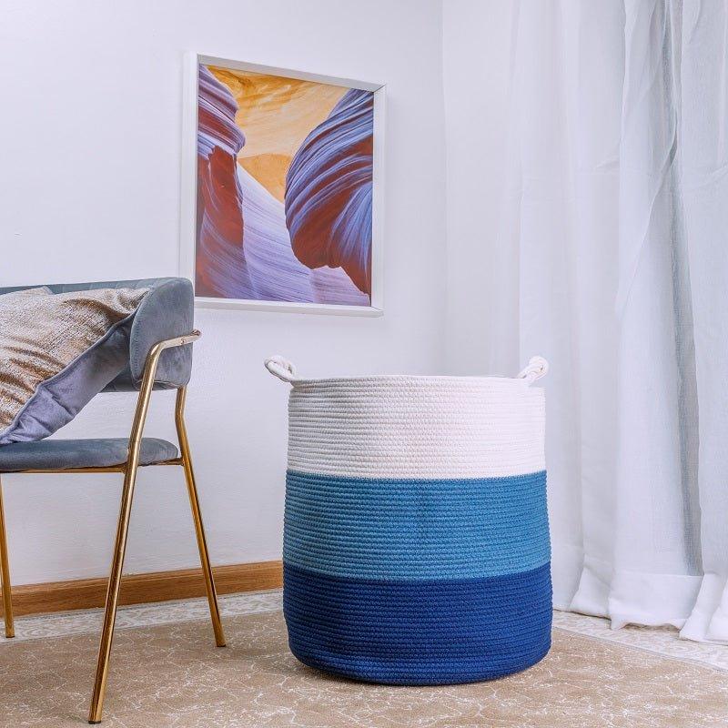 Eva Laundry / Storage Basket in blue and white, made with sturdy cotton rope, in a modern room setting.