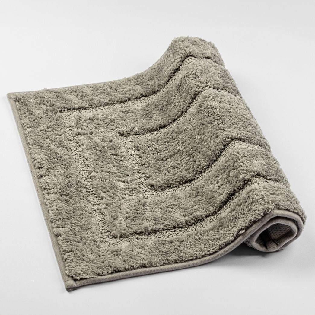 Luxurious Ola Bath Rug with anti-slip design in stylish, neutral colors.