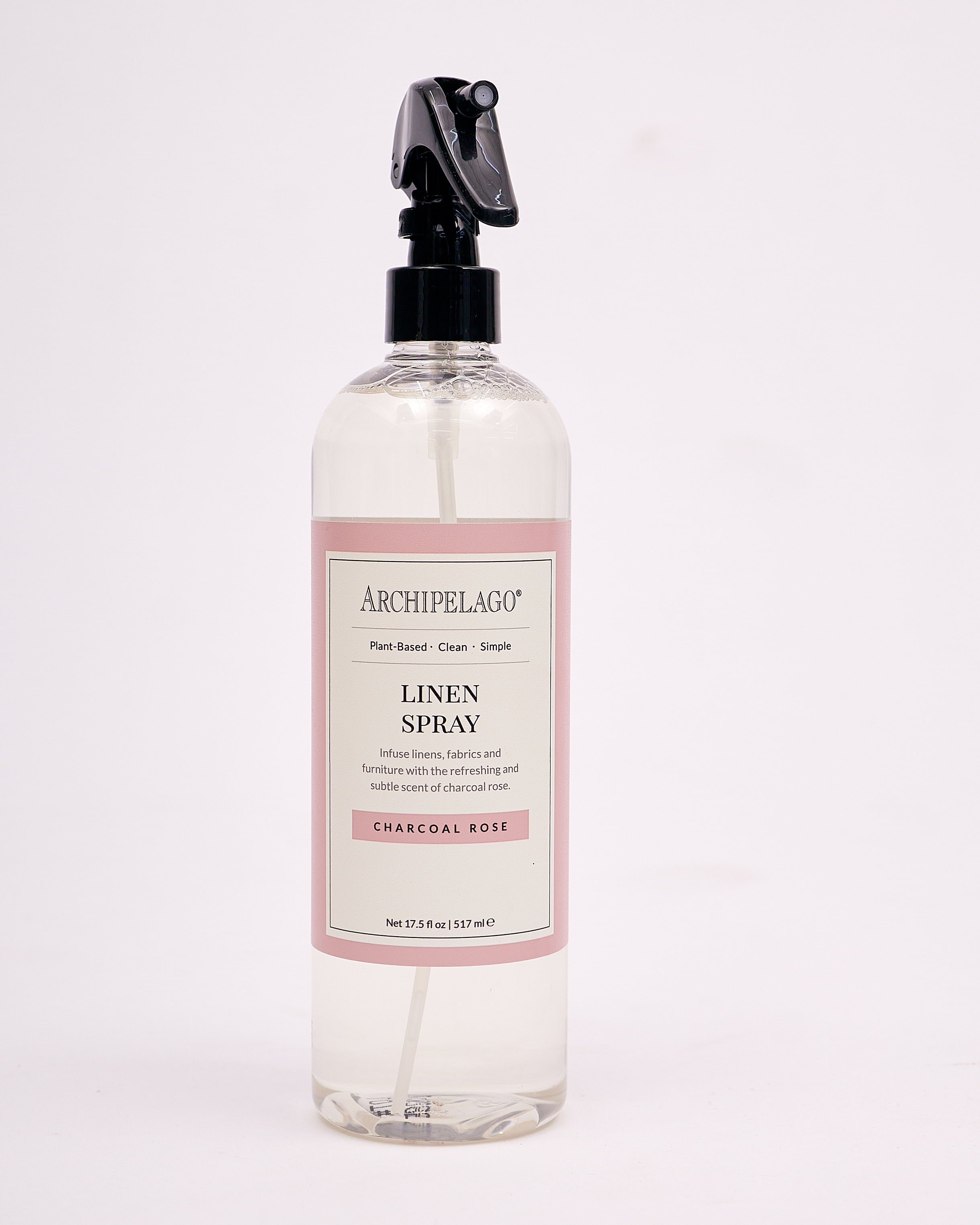 Archipelago Charcoal Rose Linen Spray bottle with floral and cedar scent for refreshing linens.