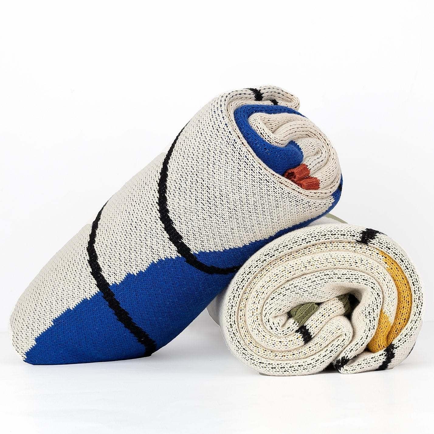 Rolled Kaly Throw Blanket featuring blue, yellow, and neutral tones with black accents from Lsa Home