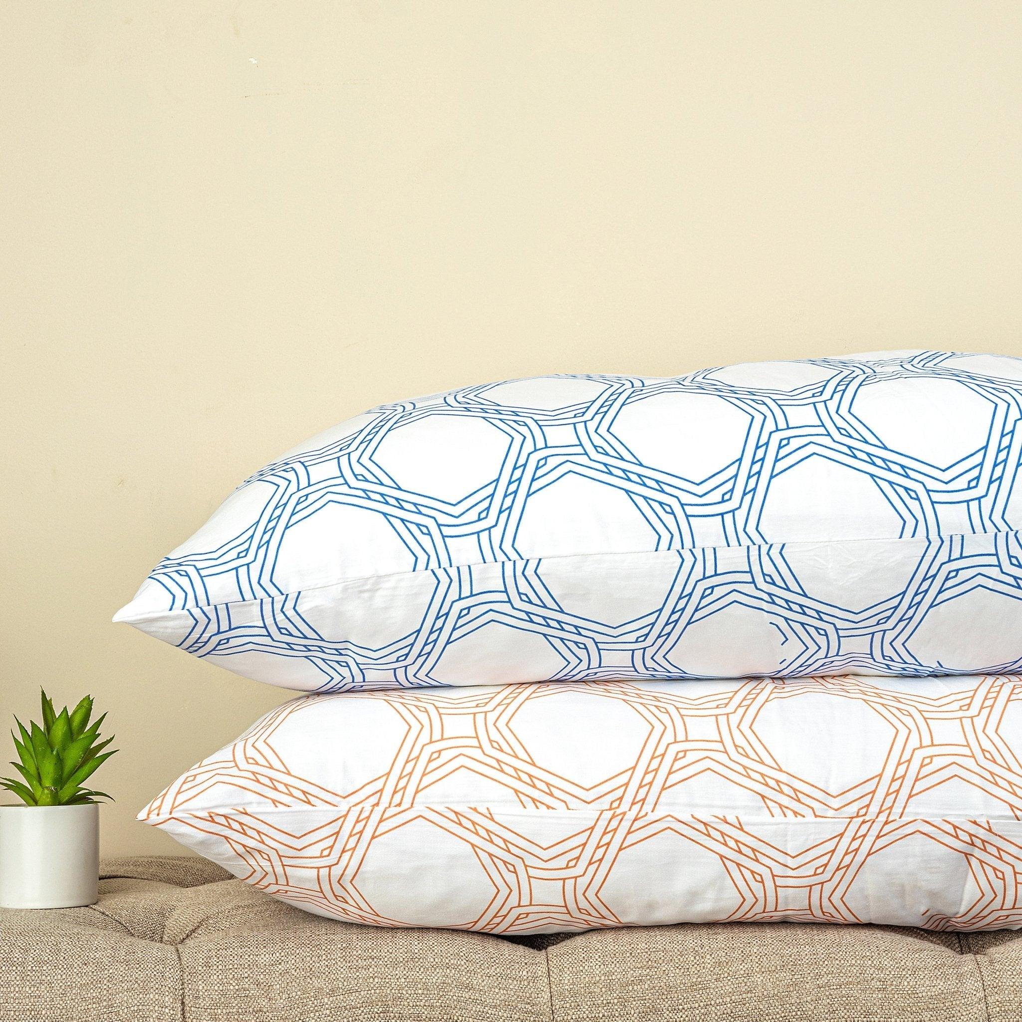 Octo Duvet Cover Set with geometric diagonal pattern in blue and rust colors on stacked pillows