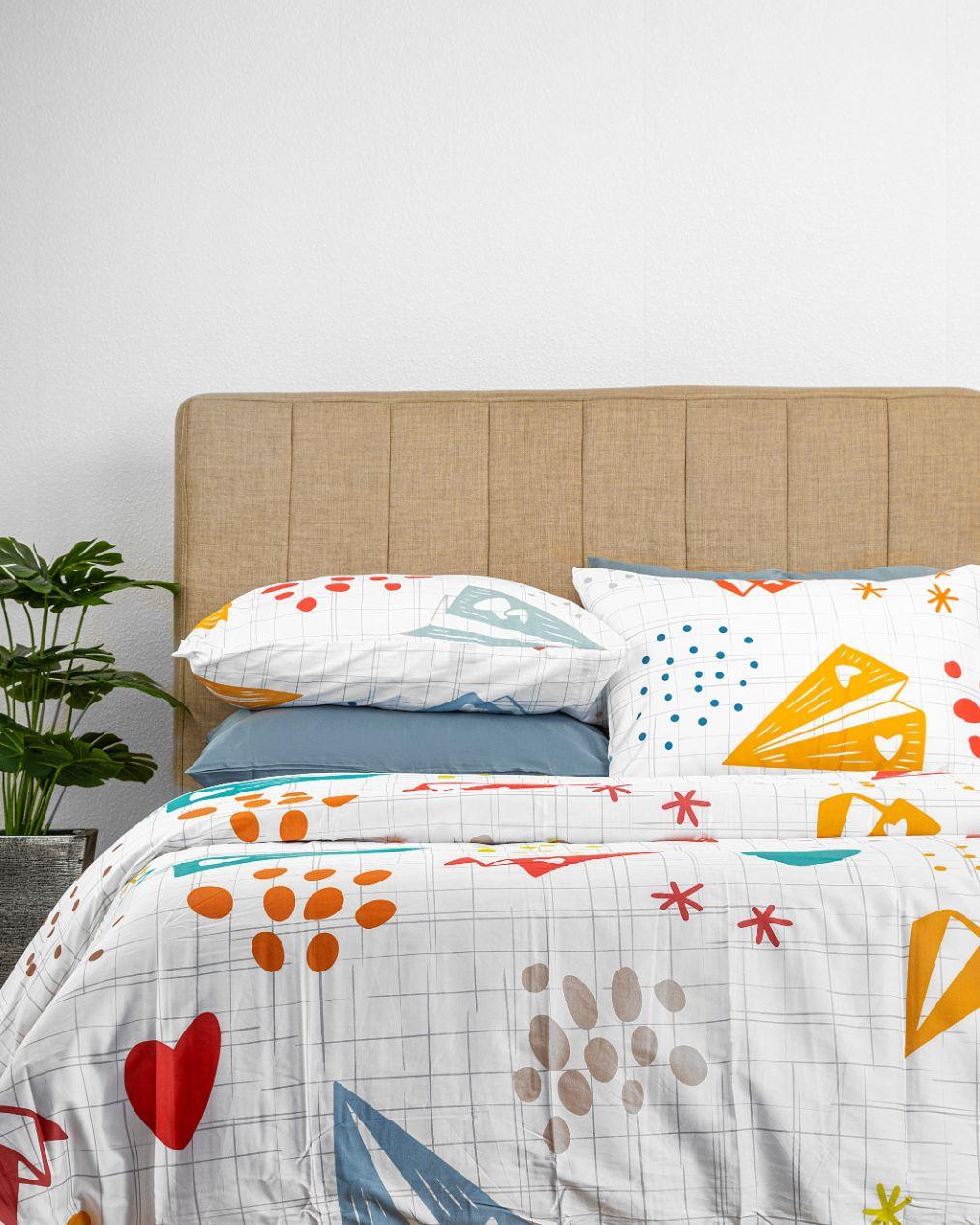 Origami Kids Duvet Cover Set with colorful origami cranes, hearts, stars, and circles pattern on a bed.
