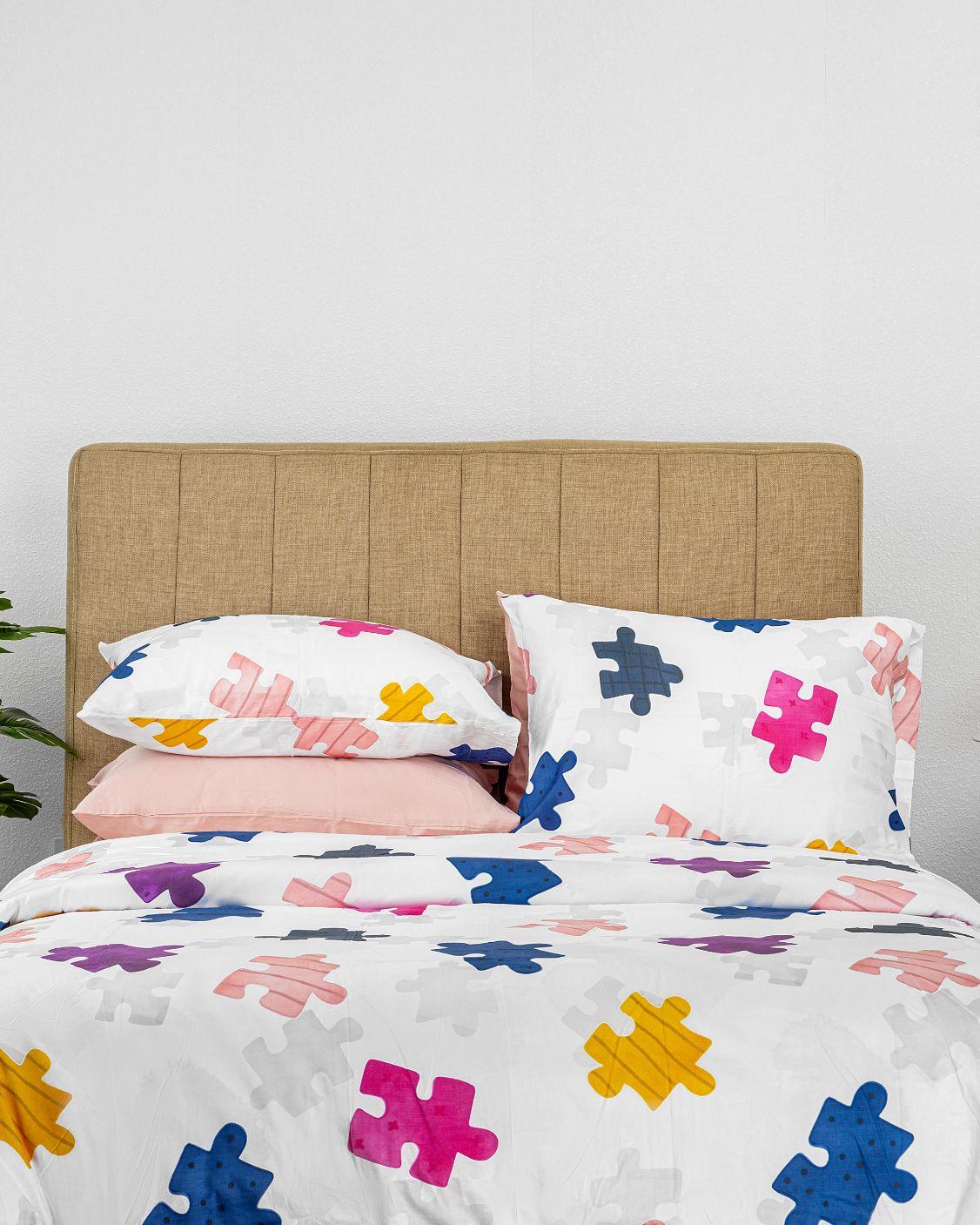 Tetris Kids Duvet Cover Set with colorful Tetrimino block patterns on white background, including duvet cover and matching pillowcases on a beige bed.
